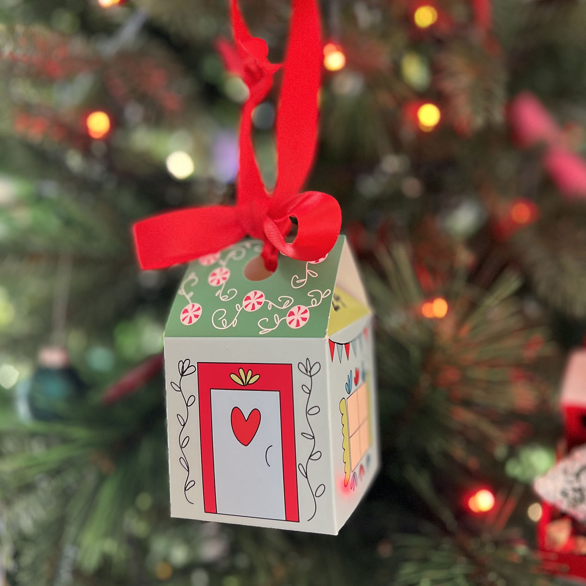 Christmas house hanging on a Christmas tree